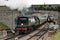 Battle of Britain Class Steam Loco No 34070 Manston arrives at Corfe Castle Station on the Swanage Railway - Corfe Castle, Dorset,