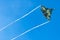 Battle fighter jet flying dives breaking clouds on a blue sky disruption of air flow