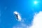 Battle fighter jet flying dives breaking clouds on a blue sky sun light