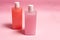 Battles of pink nacre texture cosmetics on pink background, mockup battles of cosmetics for beauty