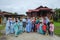 Batu Pahat, Malaysia - May 3rd, 2022 :  Happy Malay family in traditional clothing and traditional Malay house during Hari Raya.