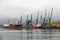Batumi, Georgia - June 26, 2021: View of the seaport of Batumi. Port cranes. Cargo terminal. Ships and berths.