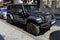 BATUMI, GEORGIA - JUNE 29, 2023: Rugged black Jeep Rubicon parked on a cobblestone street in Batumi