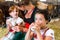 Bavaria family drinking milk in cow barn