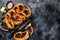 Bavarian baked Salted pretzels in a wooden tray. Black background. Top view. Copy space