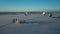 Bavarian church and radio telescopes of Raisting with snow during winter and sunset from above