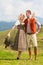 Bavarian couple in fashionable leather pants and dirndl