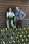 Bavarian couple standing behind a wooden fence