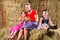 Bavarian family sitting on hayloft with pretzels