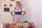 Bavarian girl in dirndl in front of a table with ingredients for baking.