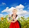Bavarian girl in tracht dress dirndl in sunflower field