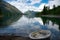 Bavarian lake Walchensee with boat in front and mountains in the background