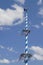 Bavarian maypole in front of white blue cloud sky