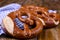 Bavarian pretzel decorated with a blue and white cloth on a rustic wooden board - Munich Oktoberfest. Background and