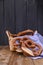 Bavarian pretzel decorated with a blue and white cloth on a rustic wooden board - Munich Oktoberfest. Baking in a basket