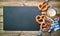 Bavarian pretzels with silverware and beer stein on wooden table