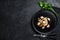 Bavette pasta with baby octopus. Black background. Top view. Space for text