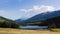 The Bay of the Gods at Kanas Lake. Tranquil water, trees, mysterious clouds.