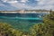 Bay of Ibiza coastline with turquoise water and yachts on sunny summer day. View to the Port de Sant Antoni de Portmany