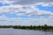 Bay with a jetty for boats sunny cloudy day blue sky in the clouds