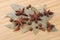 Bay leaf, allspice, and star anise on a wooden table