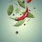 Bay leaves, rosemary, dill, black and fresh red hot peppers flying on teal gradient background