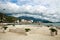 Bay in seaside town with boats, houses in green mountains on blue sky.Tivat, Montenegro