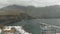 Bay for yachts off the coast of the Atlantic Ocean on an overcast day - aerial view. Massive mountains of high altitude