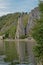 Bayard rock formation, reflecting in the water of river Meuse inin Dinant, Belgium