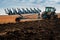 Baykivtsi, Ternopil region, Ukraine - October 18, 2019: plowing field, tractor with plow preparing the field for sowing