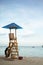 Baywatch chair in a beautiful beach empty at summer sunset.