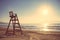 Baywatch chair in empty beach at sunset