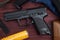 BB Gun, Old Airsoft Pistol Toy and Magazine with BB Gun Bullets on Wood Background