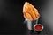 BBQ Chicken fried stripes in a metal bucket onblack background with sauce food
