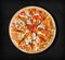 BBQ chicken pizza on a black background.