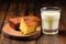 bbq cornbread with a glass of milk on a wooden coaster