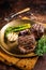 BBQ grilled Fillet Mignon Steak with asparagus, beef tenderloin meat. Dark background. Top view