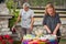 BBQ grilling party. Couple in garden making barbecue outdoors