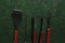 BBQ instruments kit - tongs, spatula, fork, skewer - close up isolated on green grass background flat lay