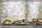 Bbq party fest Assortment various barbecue raw food meat, on plates and grid on an old blurred flint wall background