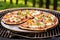 bbq pizza with bubbling cheese on a backyard grill