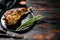 BBq Roasted goat leg. Farm meat. Dark Wooden background. Top view. Copy space