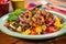 bbq spiced shrimp atop colorful vegetable salad