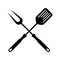 BBQ tools. Spatula and fork crossed