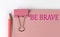 BE BRAVE word on the pink paper with pink pencil