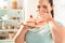 Be on Diet. Chubby girl standing in kitchen crying over plate with desserts unhappy close-up