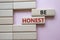 Be honest symbol. Wooden blocks with words Be honest. Beautiful pink background. Business and Be honest concept. Copy space