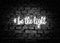 Be the light. Shining hashtag on gray brick wall background. Positive message