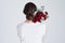 Be like a rose, strong and gentle. Studio shot of an unrecognizable woman holding flowers against a grey background.