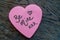 Be Mine hand wrote text on pink love heart with drawn hearts. On rustic wooden background. Love Valentines concept
